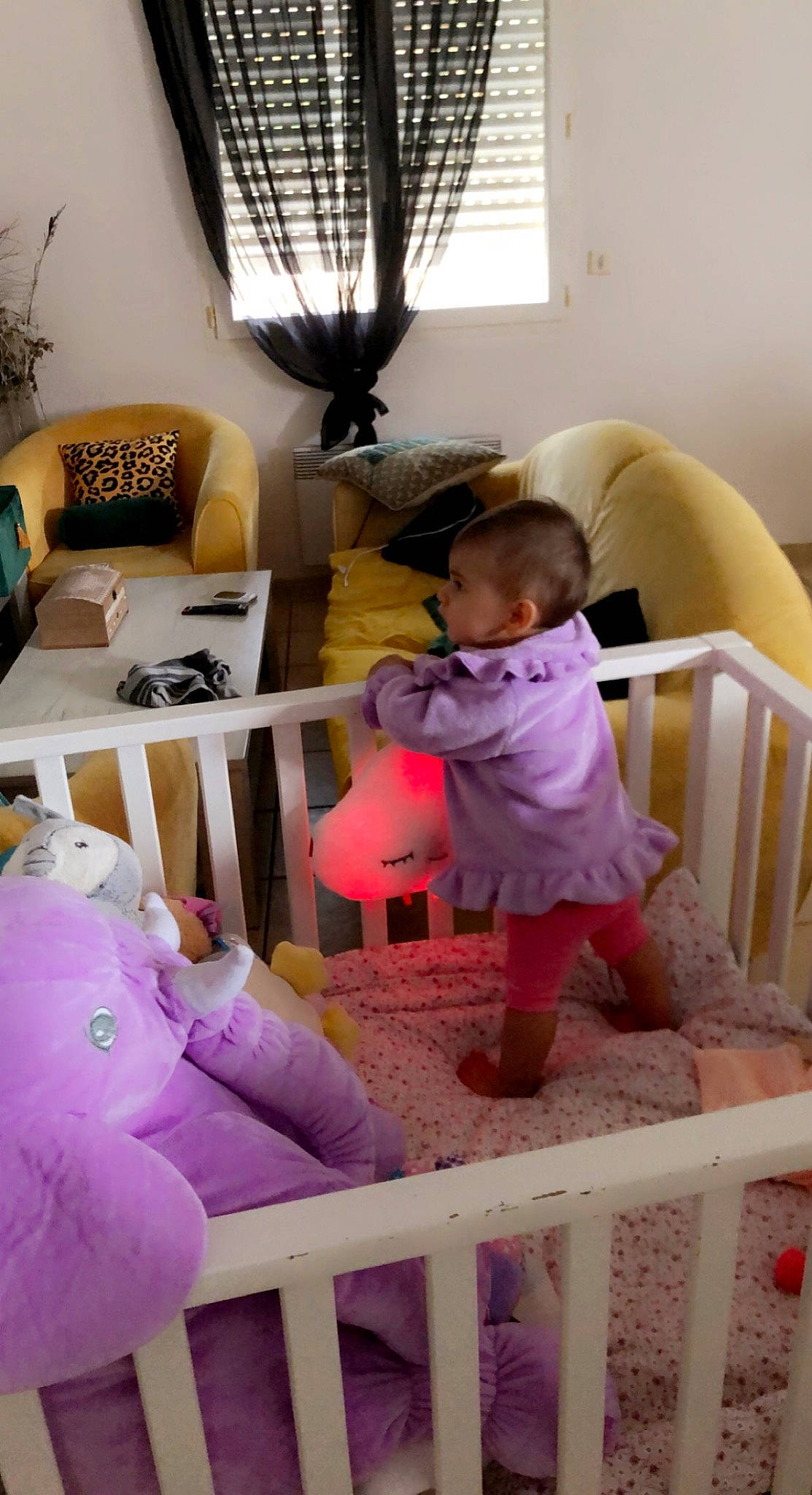 Lila participe au concours pour gagner de l'argent avec cette photo : baby, baby_products, baby_toddler_clothing, chair, child, comfort, floor, flooring, fun, hardwood, lamp, linens, magenta, person, pillow, pink, room, toddler, toy, white