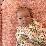 Selah is registered to the contest to win money with this photo: baby, infant, swaddle, blanket, pink, floral, pattern, soft, texture, face, head, newborn, person, cute, sleeping_area, cozy, resting, portrait, young_child, indoor