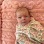 baby, infant, swaddle, blanket, pink, floral, pattern, soft, texture, face, head, newborn, person, cute, sleeping_area, cozy, resting, portrait, young_child, indoor