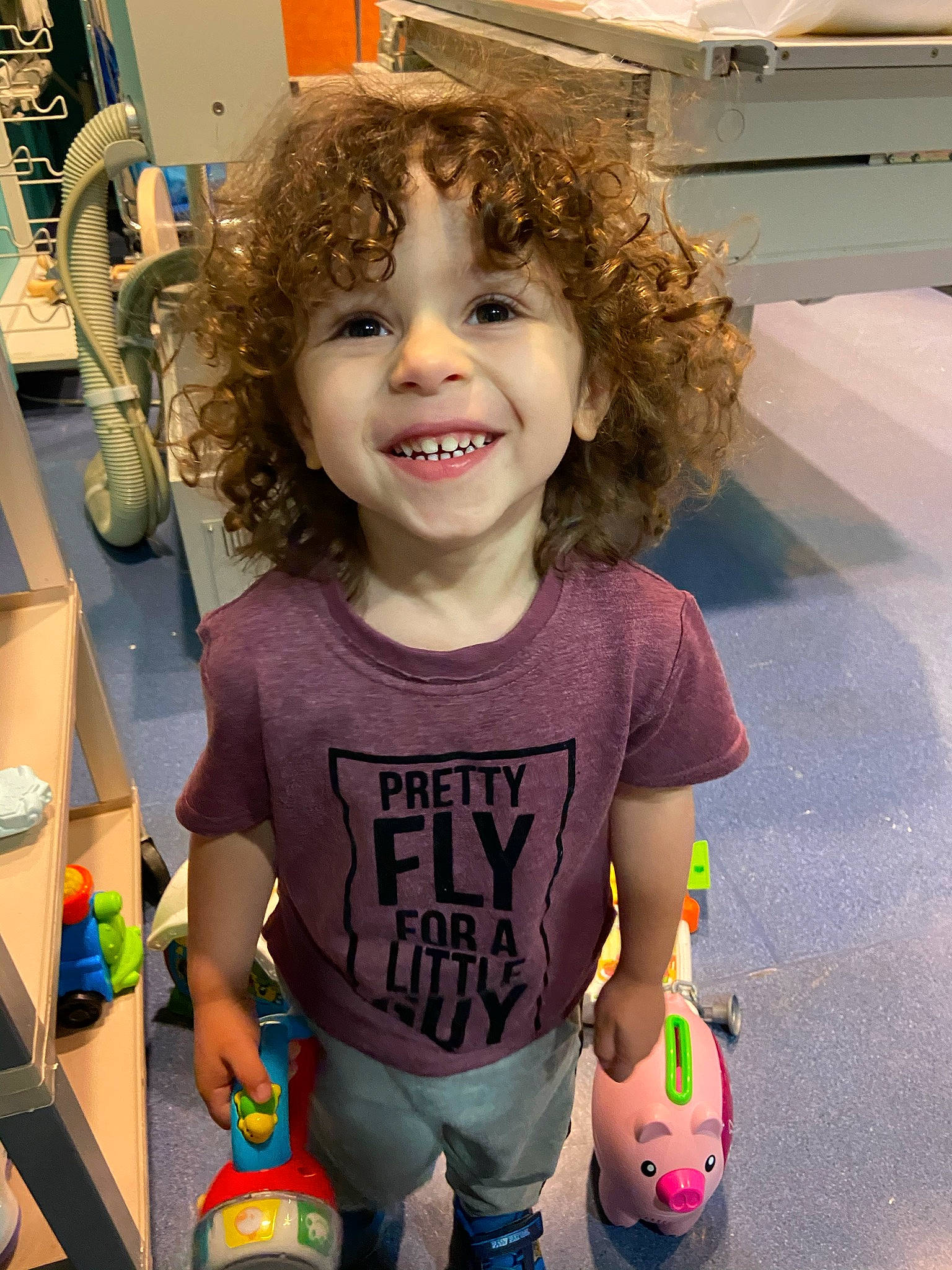 Landyn is registered to the contest to win money with this photo: baby_toddler_clothing, child, cool, eyewear, fashion_design, flooring, fun, hairstyle, happy, head, joy, person, play, ringlet, shorts, sleeve, smile, snapshot, standing, t_shirt