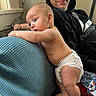 baby, diaper, man, hoodie, couch, indoor, curious, smile, skin, blue, texture, person, infant, child, casual, adult, furniture, home, light, relax