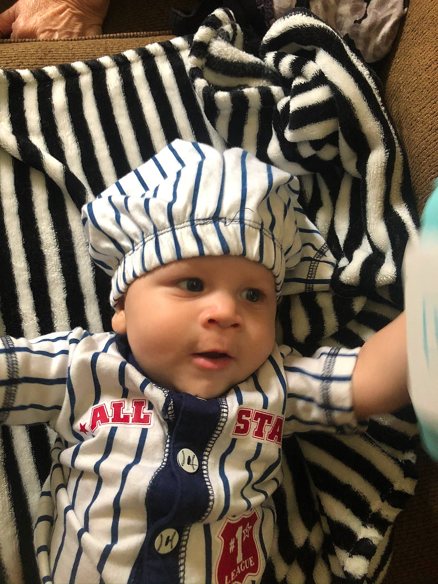Kenai is registered to the contest to win money with this photo: baby, cheek, child, cool, hat, headgear, headwear, outerwear, person, product, toddler