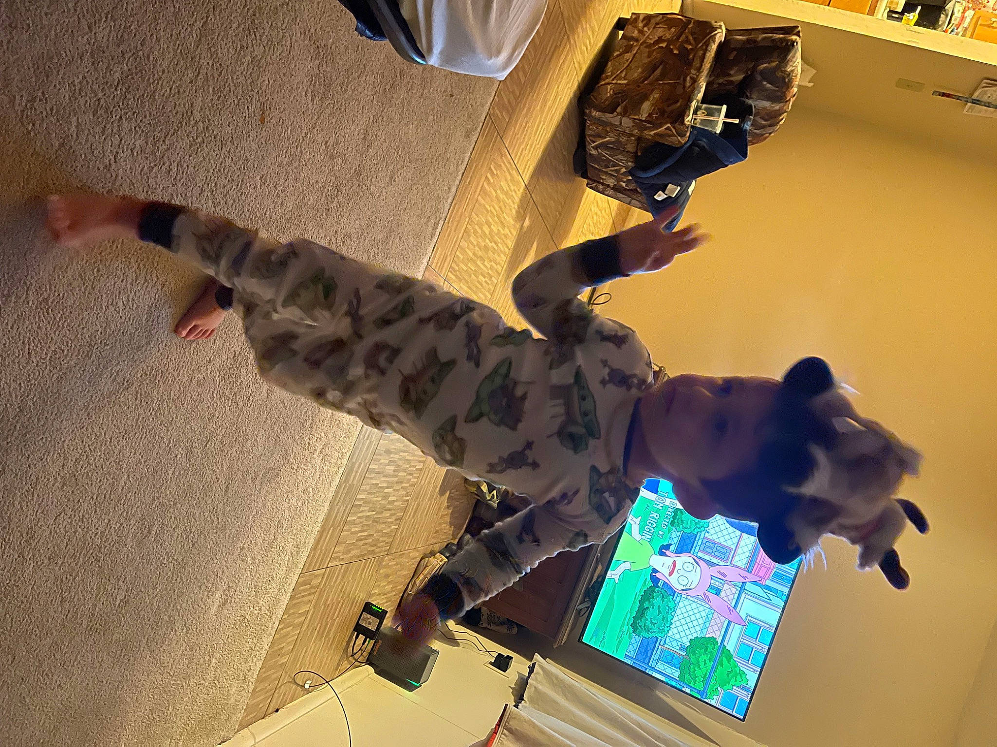 Harrison is registered to the contest to win money with this photo: art, ceiling, display_device, eyewear, fictional_character, flooring, fun, light, machine, pattern, person, personal_protective_equipment, room, shadow, space, visual_arts