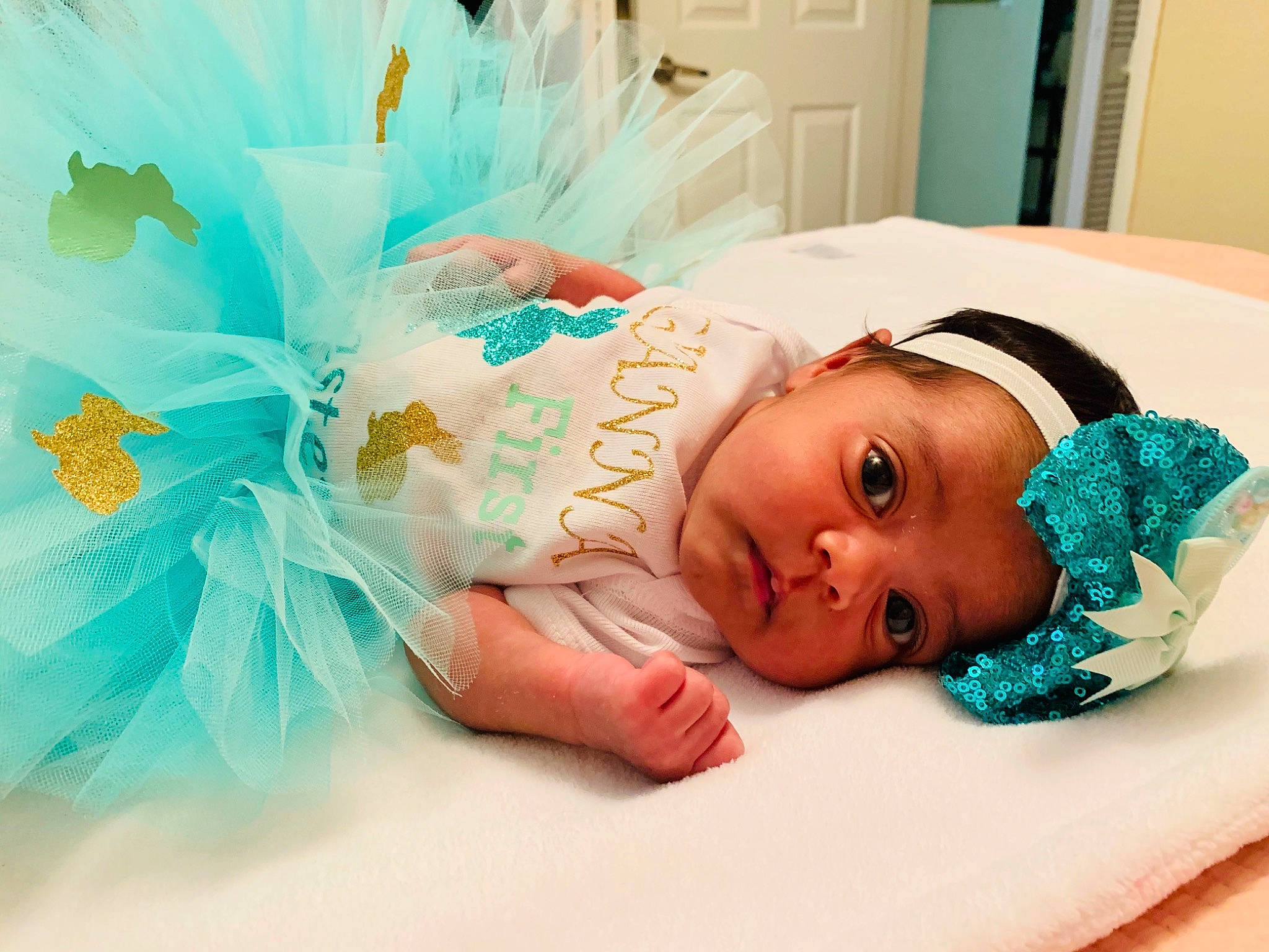 Gianna joined the competition — help win amazing prizes! aqua, azure, baby, baby_toddler_clothing, child, comfort, door, event, fashion_accessory, hair_accessory, happy, headband, headgear, headpiece, linens, person, pink, product, room, textile