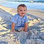 toddler, child, beach, sand, ocean, water, waves, blue_shirt, sunlight, outdoor, nature, smile, happy, playing, summer, vacation, sea, sky, young_child, sunshine