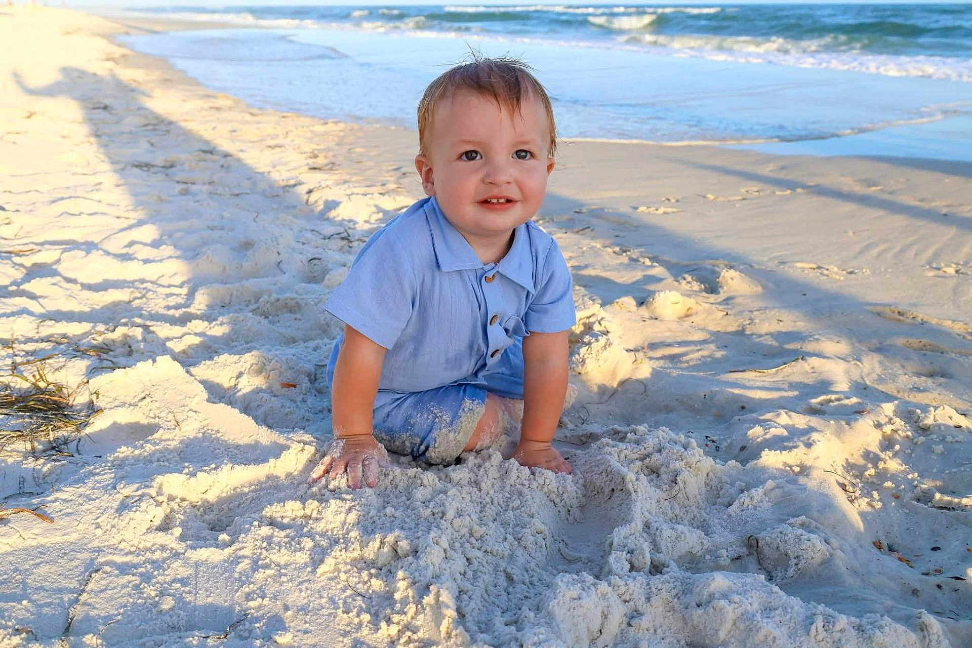 Samuel Levi joined the competition — help win amazing prizes! toddler, child, beach, sand, ocean, water, waves, blue_shirt, sunlight, outdoor, nature, smile, happy, playing, summer, vacation, sea, sky, young_child, sunshine