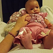 Erin'Reign is registered to the contest to win money with this photo: baby, infant, hand, feet, pink_clothing, blanket, indoor, person, child, cute, soft_toys, home, portrait, relaxing, comfort, holding_hand, fabric, sleepwear, newborn, family