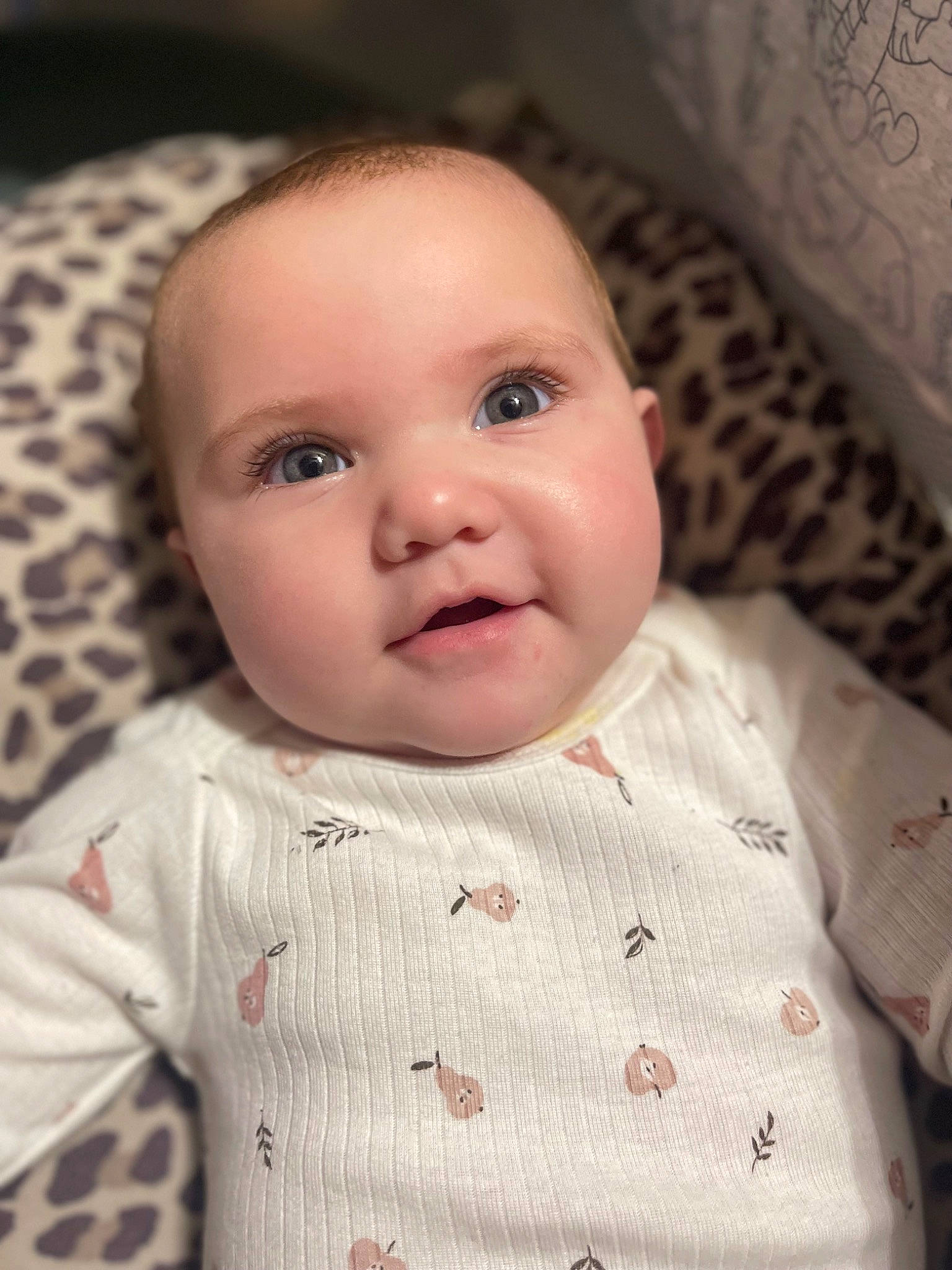 Raelynn is registered to the contest to win money with this photo: baby, baby_toddler_clothing, cheek, child, collar, comfort, eye, eyebrow, eyelash, iris, linens, lip, mouth, nose, pattern, person, sitting, skin, sleeve, smile