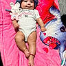 baby, infant, blue_hat, onesie, plush_toy, pink_blanket, smiling, cute, child, lying_down, soft_toy, face, happy, indoors, closeup, adorable, legs, hand, foot, red_bracelet