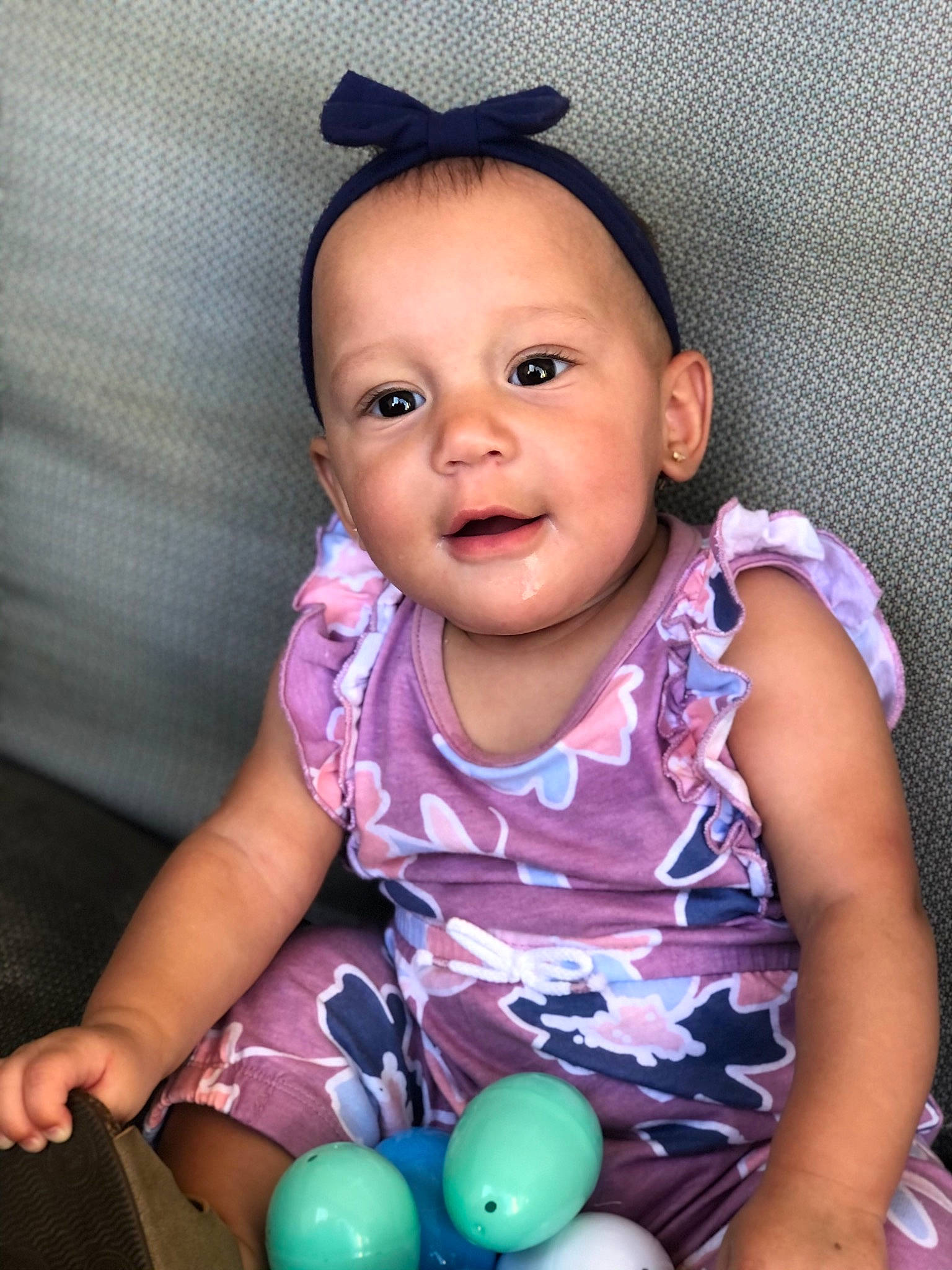 Jaelynn is registered to the contest to win money with this photo: arm, baby_toddler_clothing, balloon, blue, cheek, child, eyelash, finger, fun, hand, happy, lip, neck, nose, organ, person, pink, purple, skin, sleeve