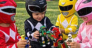 Nathaniel joined the competition — help win amazing prizes! child, costume, helmet, toy, grass, outdoor, play, action_figure, red, black, yellow, pink, superhero, team, fun, kid, game, park, sitting, children