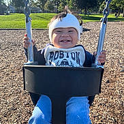 Eliot joined the competition — help win amazing prizes! toddler, child, swing, playground, helmet, smile, happy, outdoor, grass, trees, sunshine, clothing, park, daytime, person, seat, metal, holding, fun, woodchips