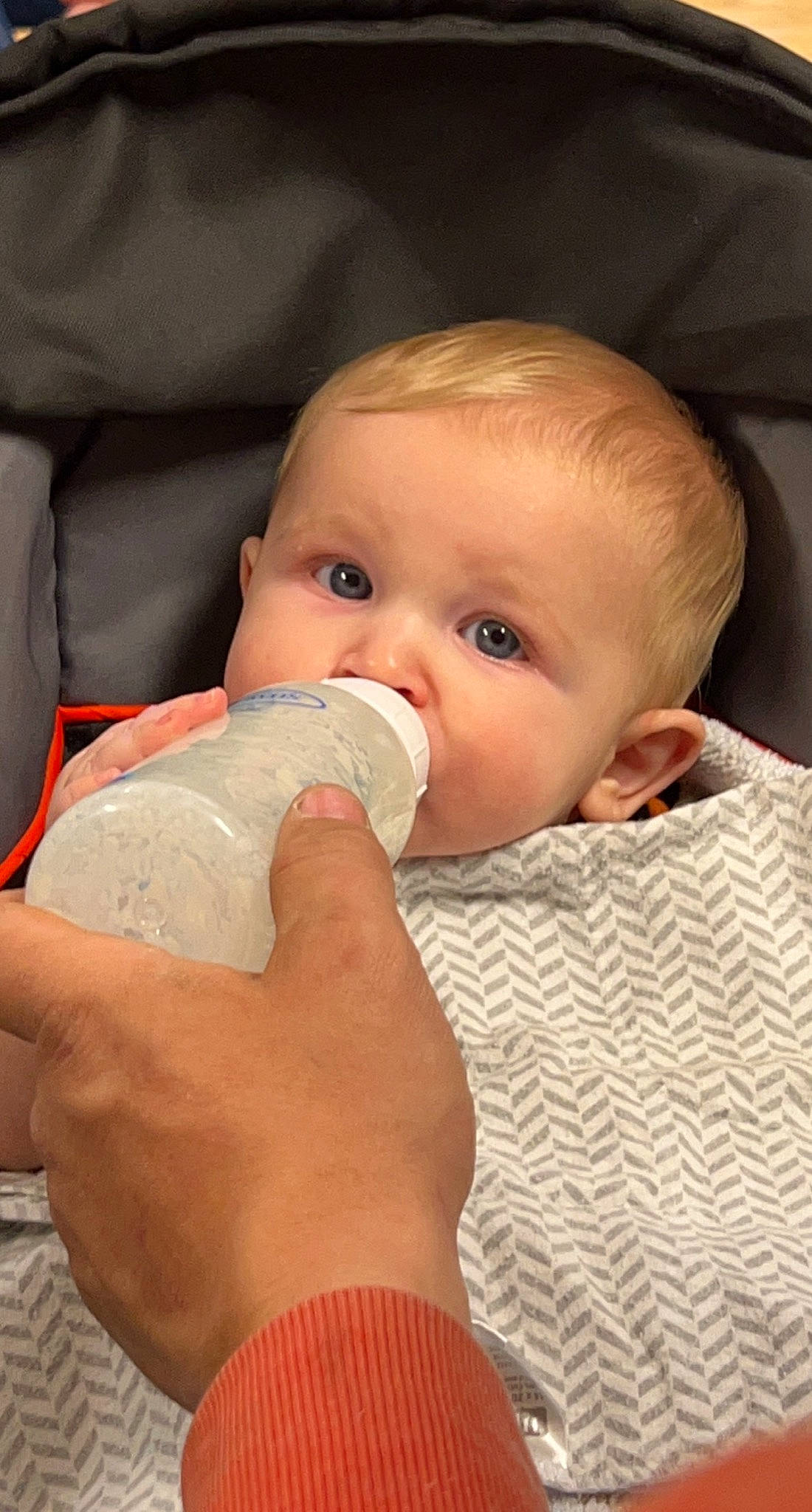 Oliver is registered to the contest to win money with this photo: baby, baby_bottle, baby_toddler_clothing, bottle, cheek, chin, drinkware, ear, eyebrow, face, hairstyle, hand, head, human_body, iris, leg, lip, mouth, nose, person