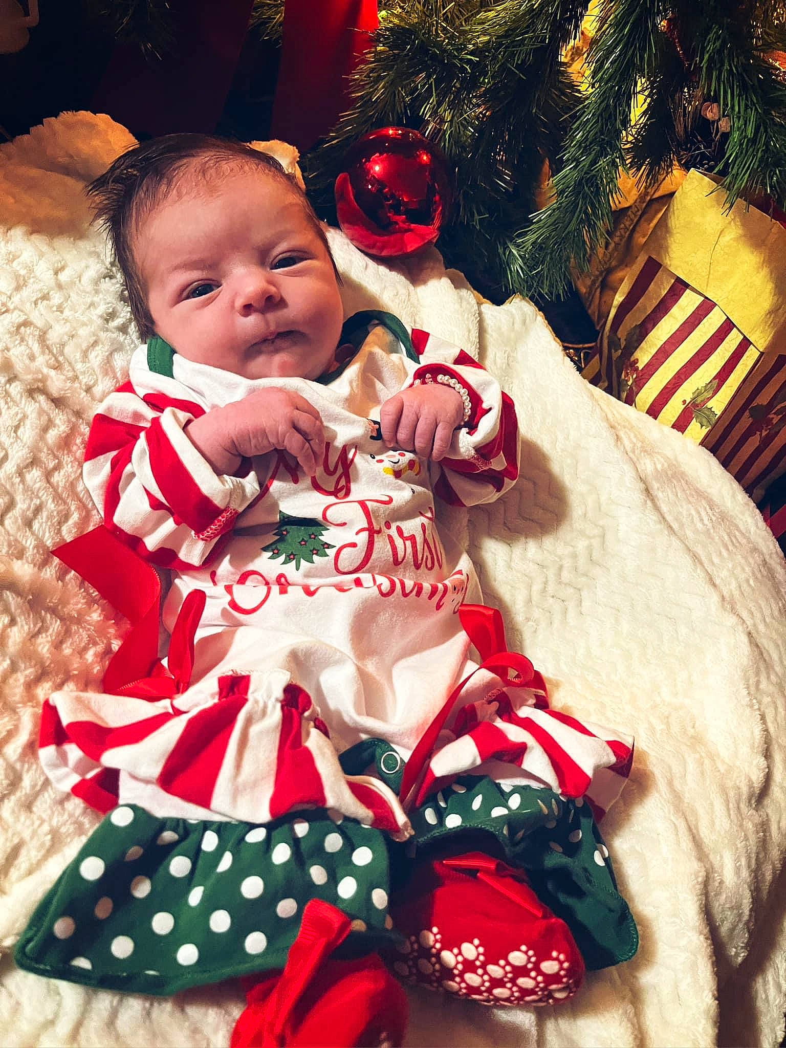 Lucy is registered to the contest to win money with this photo: baby, baby_toddler_clothing, carmine, child, christmas, christmas_decoration, christmas_eve, christmas_ornament, christmas_tree, event, fictional_character, happy, holiday, holiday_ornament, ornament, person, red, santa_claus, sleeve, toddler