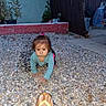 baby, child, crawling, outdoor, gravel, garden, patio, plants, flowerpot, fence, brick_wall, house, curious, face, portrait, long_sleeves, hair_bow, flip_flop, adult_foot, daylight