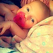 Angelia joined the competition — help win amazing prizes! baby, pacifier, blanket, soft, close_up, infant, sleepwear, face, cute, child, resting, comfort, portrait, bed, skin, young, peaceful, pink, pattern, indoor