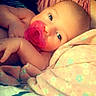 baby, pacifier, blanket, soft, close_up, infant, sleepwear, face, cute, child, resting, comfort, portrait, bed, skin, young, peaceful, pink, pattern, indoor