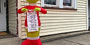 Henry is registered to the contest to win money with this photo: cat, fluffy_cat, inflatable, grinch, christmas, holiday_decor, sidewalk, house, window, ornaments, festive, decoration, santa_hat, naughty_list, outdoor, concrete, relaxing_cat, holiday_season, festive_lights, winter