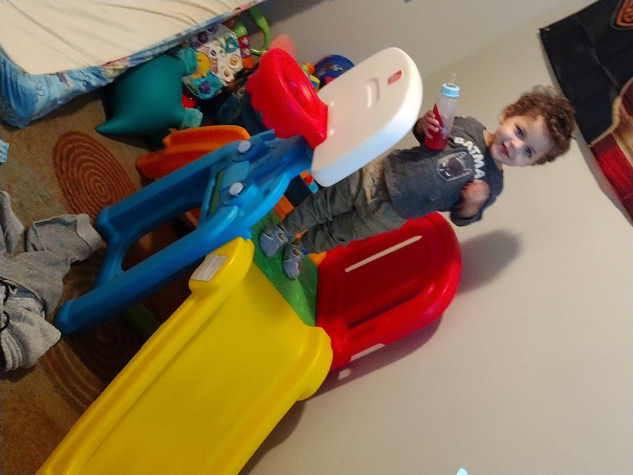 Sebastian is registered to the contest to win money with this photo: amusement_ride, baby_products, baby_toys, chair, child, chute, electric_blue, fun, joy, leisure, person, plastic, play, recreation, room, sitting, toy, toy_vehicle