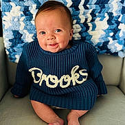 Brooks joined the competition — help win amazing prizes! baby, child, smiling, blue_sweater, knitted, name, brooks, blanket, blue, white, chair, seated, cute, portrait, indoors, happy, face, feet, cozy, warm