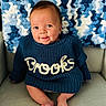 baby, child, smiling, blue_sweater, knitted, name, brooks, blanket, blue, white, chair, seated, cute, portrait, indoors, happy, face, feet, cozy, warm