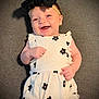 baby, smiling, headband, bow, dress, flower_print, infant, happy, lying_down, carpet, cute, child, portrait, one_person, indoors, fashion, young_child, skin, head, hand