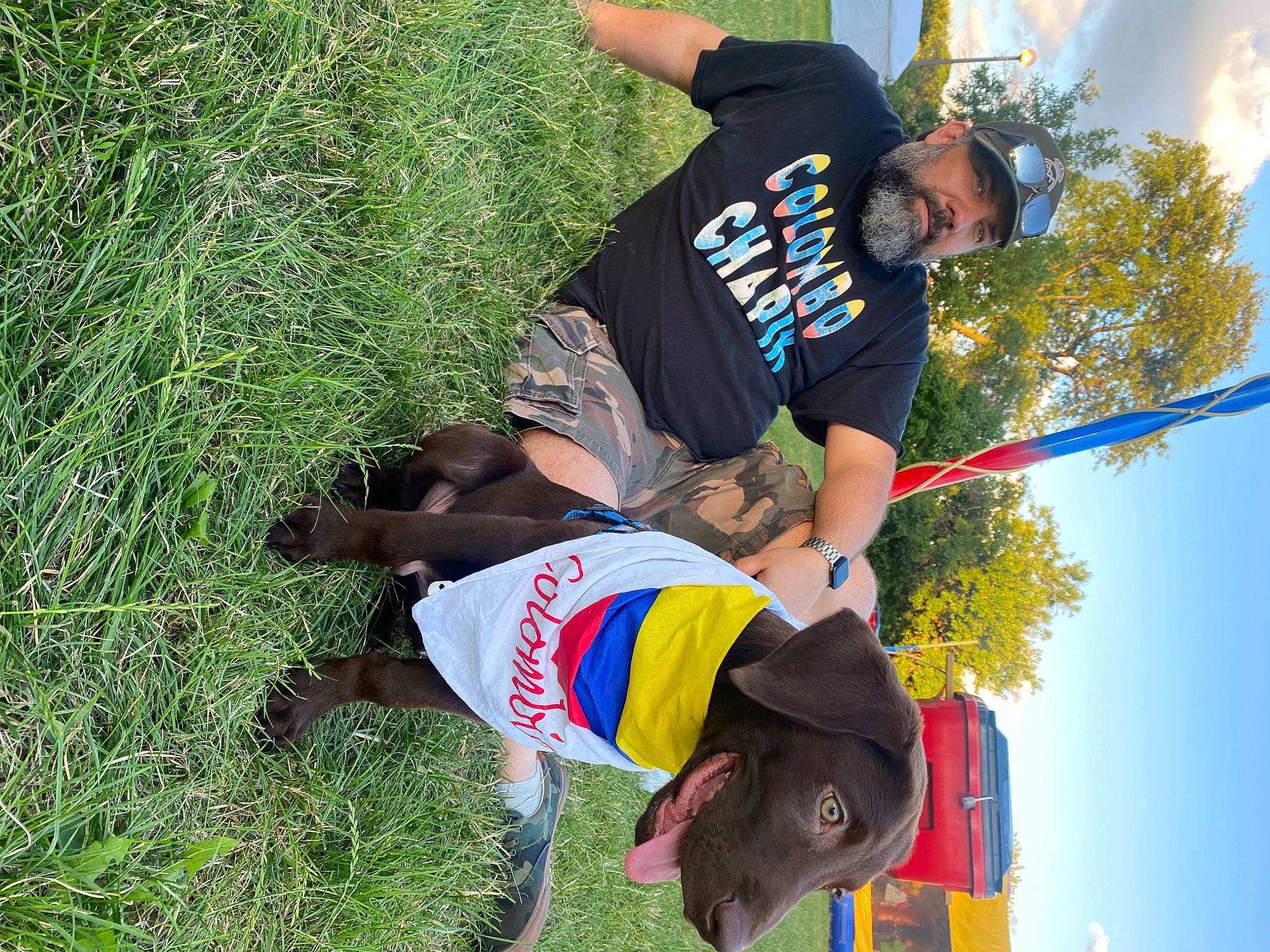 Toffee is registered to the contest to win money with this photo: adventure, carnivore, collar, dog, dog_breed, elbow, event, fun, grass, happy, leash, leisure, people_in_nature, pole, recreation, sky, sporting_group, t_shirt, tree, working_animal