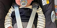 Hunter-Eli is registered to the contest to win money with this photo: baby, pacifier, car_seat, child, infant, straps, seatbelt, black_clothing, striped_shirt, safety, comfort, indoors, cute, smiling, young_child, face, hands, head, car_safety, happiness