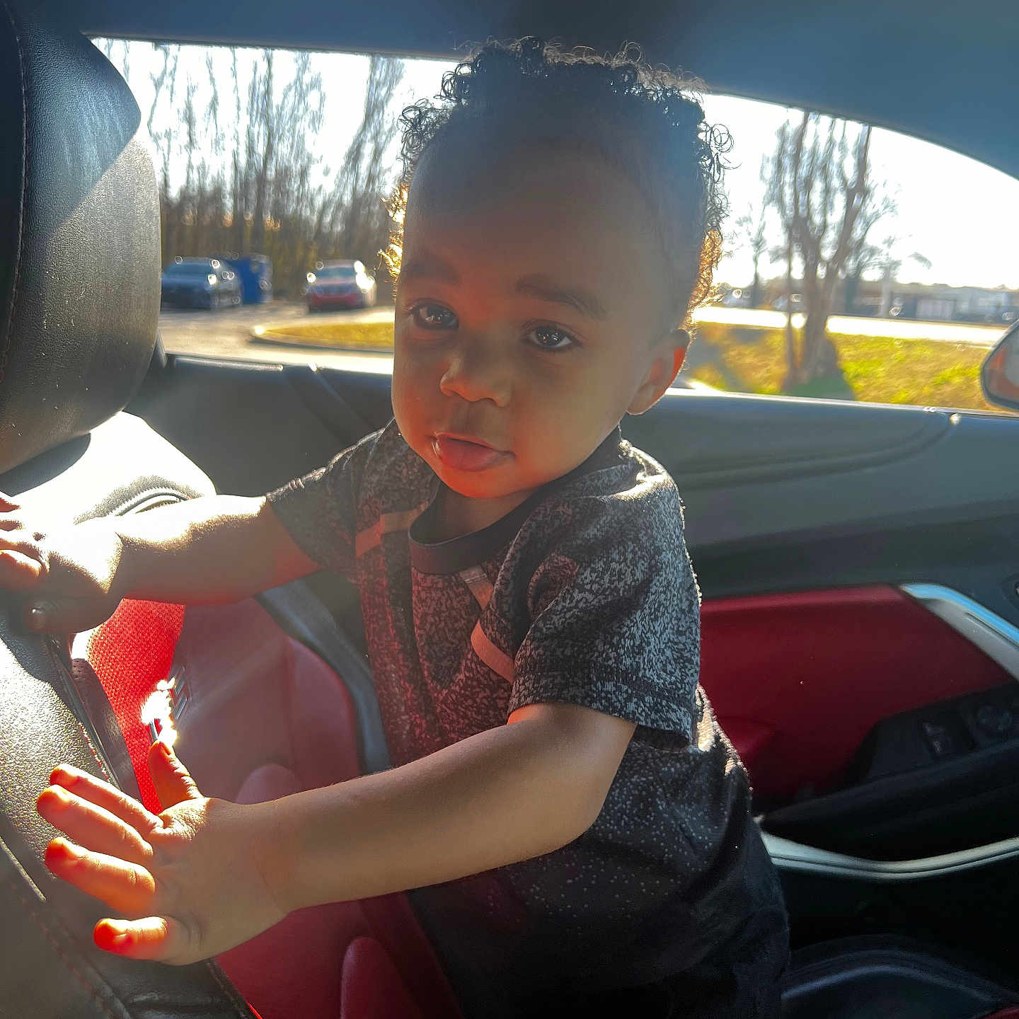 Tylan is registered to the contest to win money with this photo: alloywheel, baby, bodypart, car, carwheel, cushion, face, finger, hand, head, homedecor, machine, person, photography, portrait, sitting, spoke, tire, transportation, vehicle
