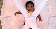 Fawlyn joined the competition — help win amazing prizes! baby, infant, play_mat, plush, pink, soft, cushion, child, cute, indoor, carpet, person, adorable, lying_down, wide_eyes, curious, crossbars, toy, young_child, comfort