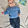 Mattía participe au concours pour gagner de l'argent avec cette photo : baby, infant, blue_sweater, black_pants, smiling, lying_down, white_blanket, milestone_card, 5_months, cute, child, portrait, cozy, happy, indoors, soft_texture, clothing, socks, face, young