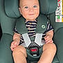 baby, child, car_seat, maxi_cosi, seat_belt, smile, happy, blue_eyes, striped_shirt, infant, cute, sitting, safety, legs, feet, hand, headrest, car_interior, portrait, closeup