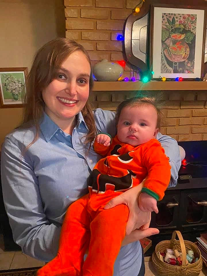 Alice is registered to the contest to win money with this photo: baby, basket, child, event, fun, happy, holiday, joy, lap, orange, person, picture_frame, room, sitting, smile, stuffed_toy, toddler, toy, vacation