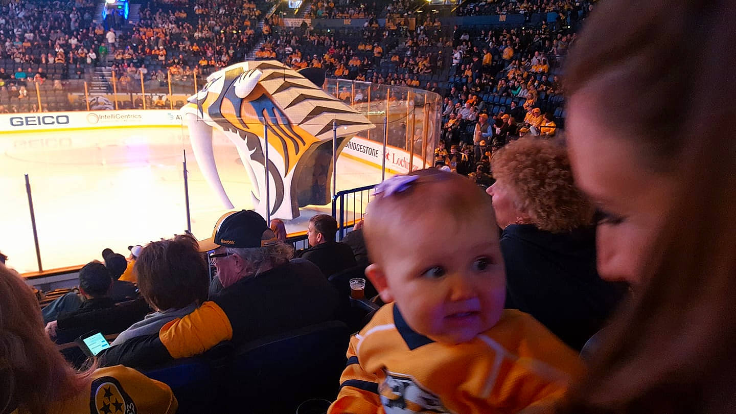 Melanie joined the competition — help win amazing prizes! baby, championship, competition_event, crowd, event, fan, field_house, flag, fun, gesture, leisure, person, player, product, stadium, t_shirt, team, team_sport, toddler, tournament