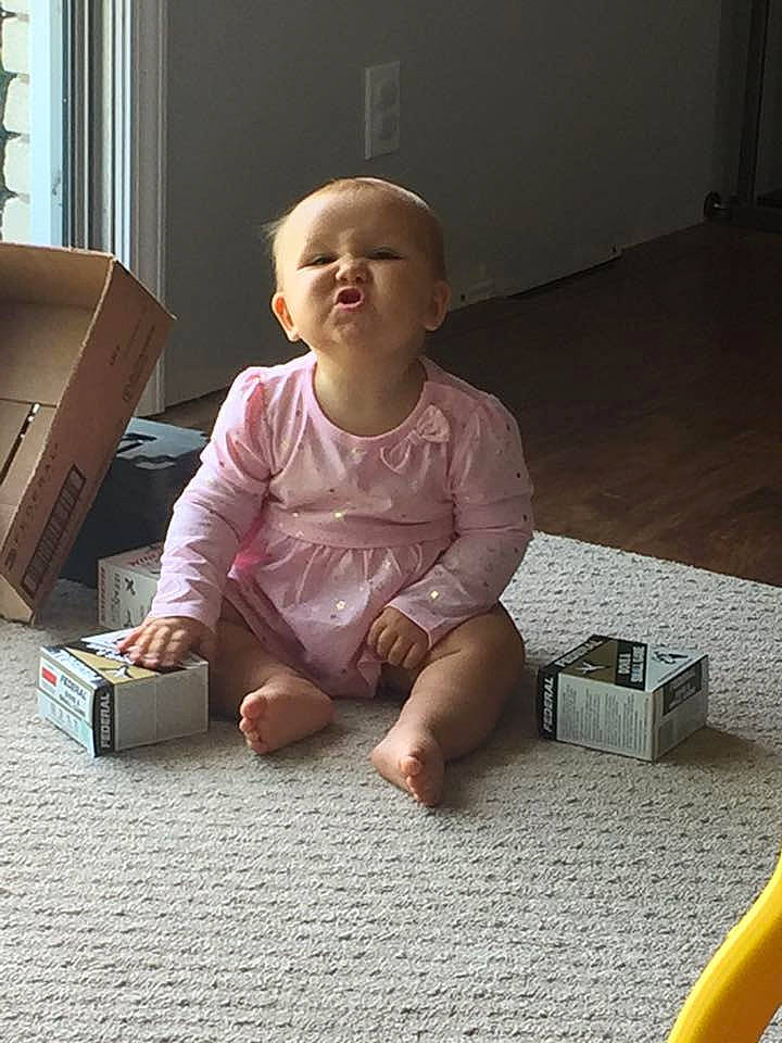 Melanie is registered to the contest to win money with this photo: baby, baby_toddler_clothing, barefoot, child, comfort, crawling, floor, flooring, foot, fun, hardwood, human_leg, mammal, person, play, shipping_box, sitting, smile, toddler, wood