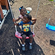 Marcello is registered to the contest to win money with this photo: children, playground, swing, smiling, outdoor, grass, sunlight, child, happy, play, rope, casual_clothing, footwear, black_hair, shorts, tshirt, summer, fun, friends, park