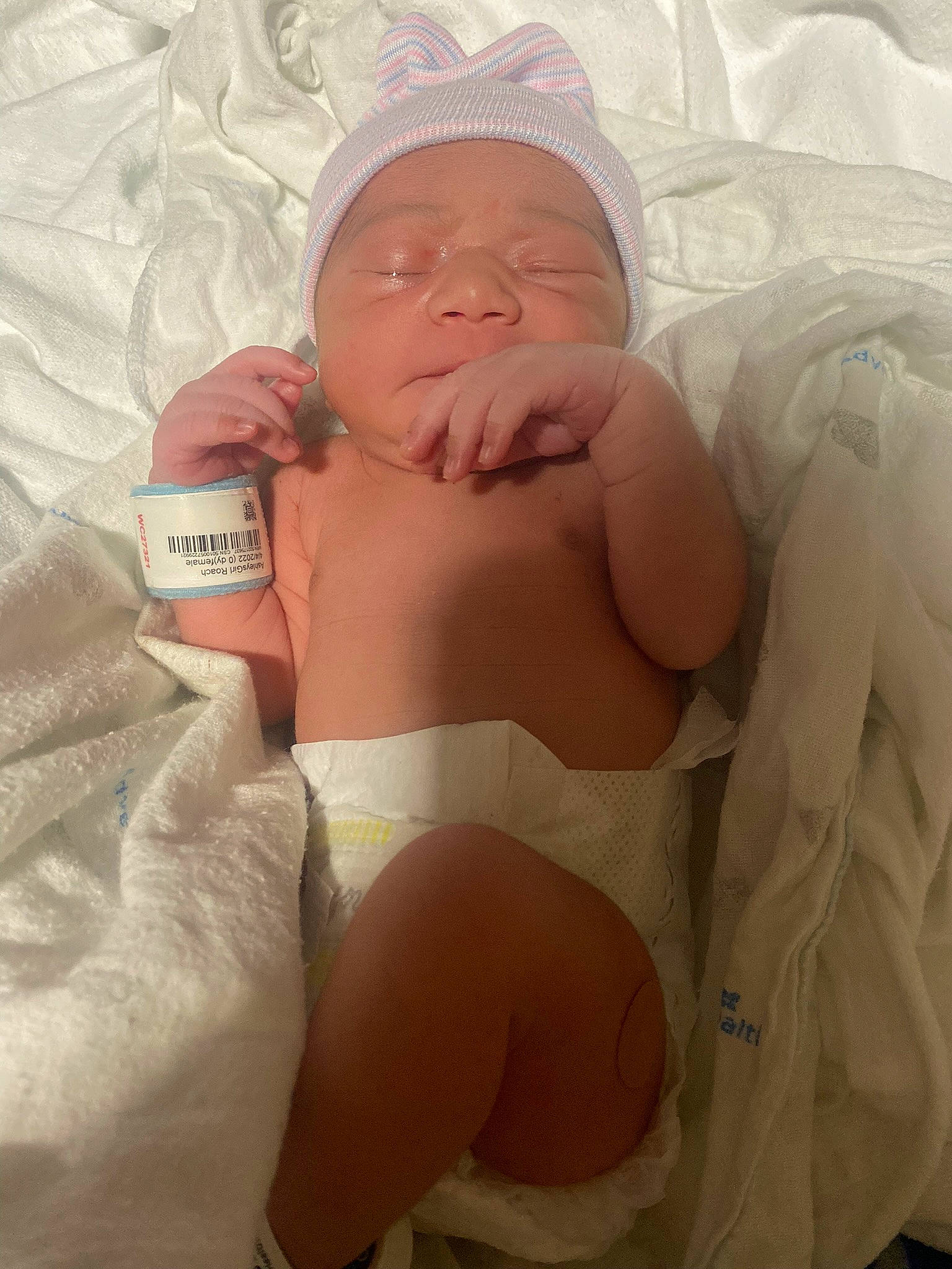 Amelia joined the competition — help win amazing prizes! abdomen, baby, baby_sleeping, barechested, bedding, chest, comfort, face, headwear, hospital, human_body, linens, mouth, neck, person, skin, smile, stomach, thigh, thumb