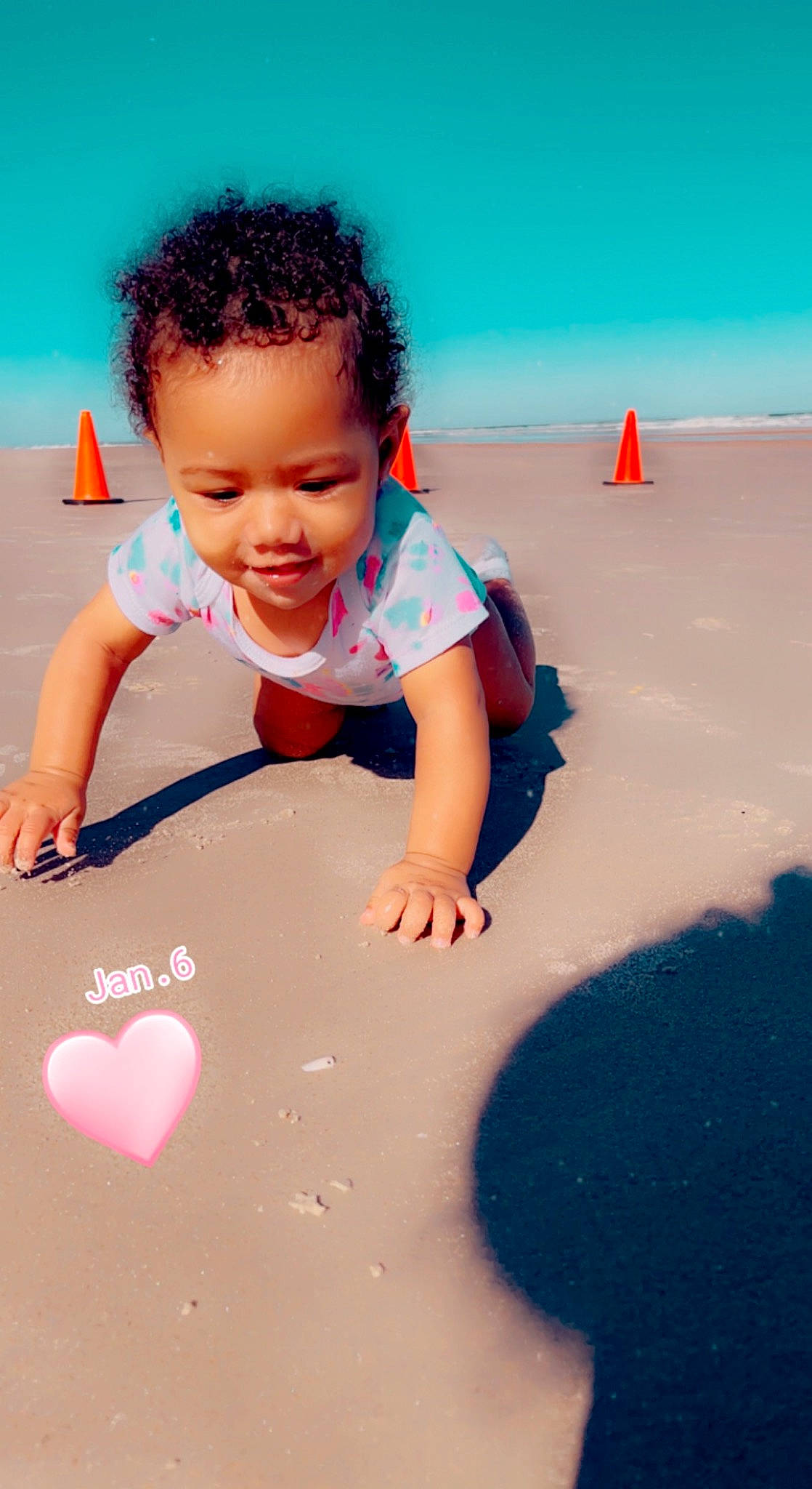 Amelia is registered to the contest to win money with this photo: baby, baby_toddler_clothing, child, flooring, fun, happy, horizon, joy, landscape, leisure, morning, people_in_nature, people_on_beach, person, play, recreation, sand, sky, smile, t_shirt