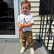 Lorenzo joined the competition — help win amazing prizes! child, boy, toddler, standing, portrait, outdoor, sunlight, doorstep, house, siding, railing, stairs, window, reflection, t_shirt, pants, sneakers, fashion, smiling, daylight