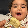bird_print, child, clothing, comfort, couch, curly_hair, delicious, face, food, hand, happy, ice_cream, indoor, mouth_open, pattern, sitting, smiling, snack, sweet, toddler