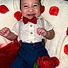 adorable, baby, blue_shorts, bow_tie, button_shirt, closeup, cozy, face, hair, hands, infant, laughter, plush, portrait, red_polka_dots, red_rose, smile, smiling_baby, suspenders, white_blanket