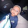 baby, blue_eyes, candid, car_interior, car_seat, child, closeup, clothing, cute, diaper_bag, flash, hat, infant, lap, night, nike, onesie, portrait, seat_back, stuffed_toy