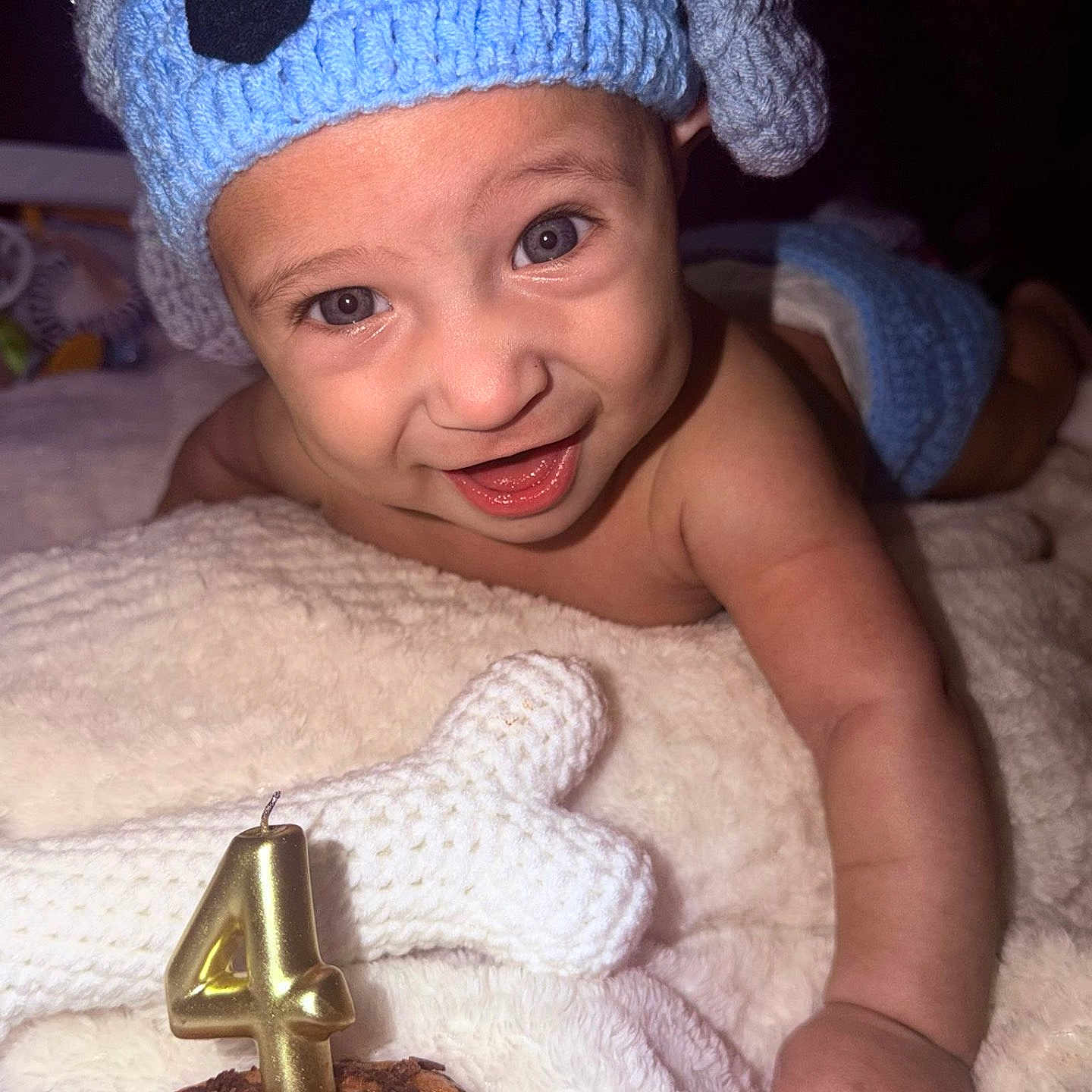 Ynfante Jeanner E is registered to the contest to win money with this photo: baby, bare_torso, blanket, blue_hat, bright_eyes, candle, celebration, closeup, crocheted, cupcake, diaper_cover, happy, indoor, infant, knit_hat, number_four, portrait, smile, soft_texture, toy