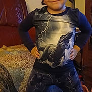 Jewlz joined the competition — help win amazing prizes! child, dinosaur, tshirt, pants, lightning, indoor, living_room, carpet, blanket, furniture, person, smile, standing, hair, face, expression, clothing, cozy, leather_chair, home