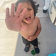 Jewlz joined the competition — help win amazing prizes! child, boy, smiling, hand, outdoor, concrete, black_shorts, water_cup, curly_hair, footwear, crocs, playful, happy, sunlight, summer, bare_chest, water_splash, expression, person, daylight