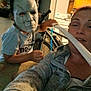 child, mask, adult, indoor, kitchen, bicycle, toy, face_mask, person, white_mask, playful, home, woman, sword, costume, casual_clothing, interaction, smile, fun, portrait