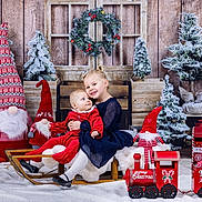 Elena a rejoint le concours — aidez-le/la à gagner de superbes lots ! baby, blue_dress, child, christmas, decorations, festive, gift_box, gnome, holiday, indoor, lantern, pine_tree, portrait, red_clothing, sled, smiling, snow, toy_train, wooden_background, wreath