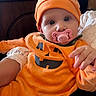 Elena participe au concours pour gagner de l'argent avec cette photo : baby, blue_eyes, child, costume, cute, fabric, face, fall, hand, hat, holding, holiday, indoor, infant, lace, orange, pacifier, person, portrait, pumpkin_costume