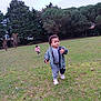 child, toddler, park, grass, trees, jacket, tracksuit, sneakers, outdoor, playing, nature, greenery, walking, running, casual_clothing, daytime, two_children, field, young_child, activity