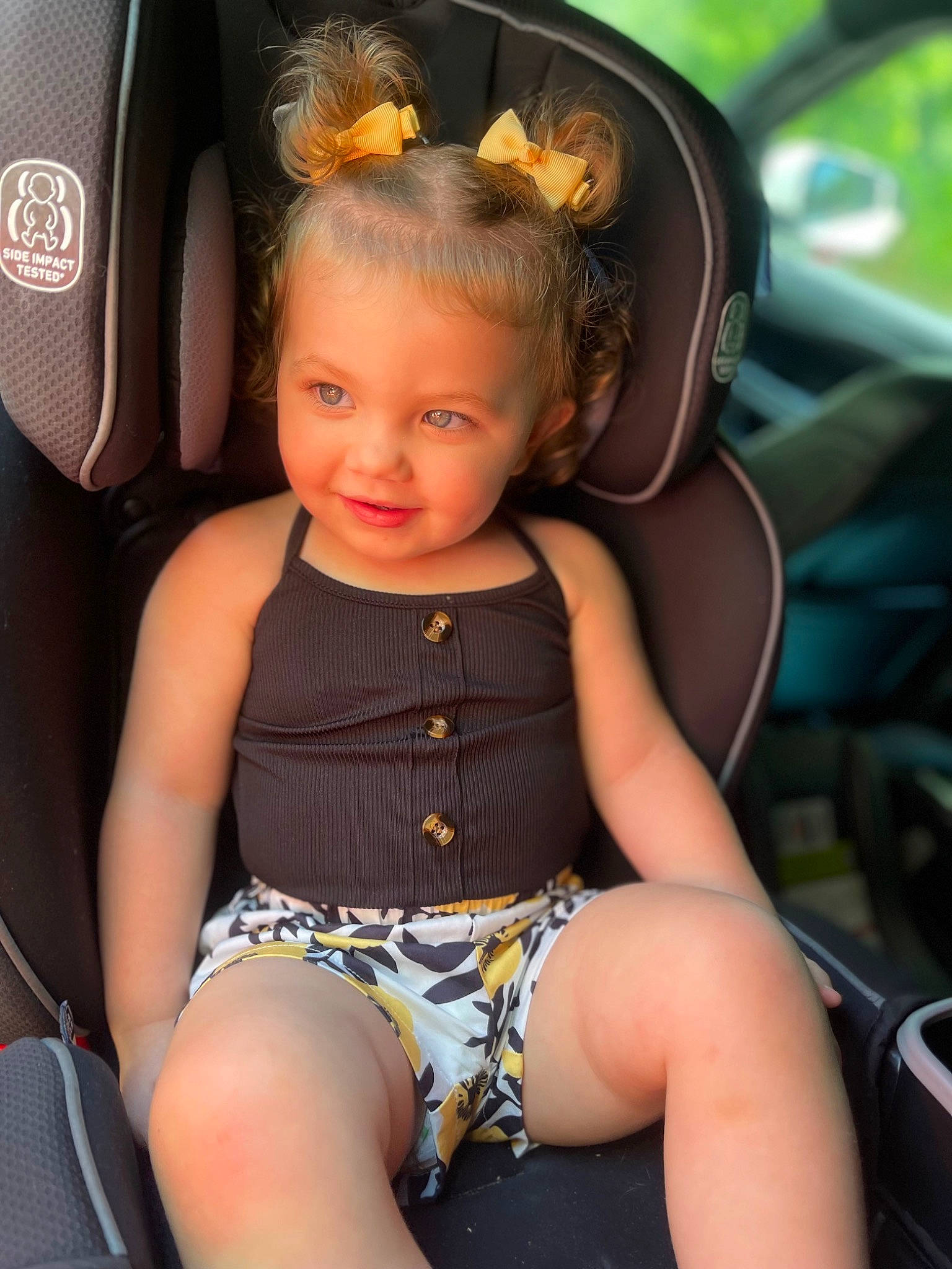 Emersyn is registered to the contest to win money with this photo: auto_part, automotive_design, baby_toddler_clothing, car_seat, car_seat_cover, face, fun, happy, head, human_leg, joy, leisure, motor_vehicle, person, sitting, skin, steering_wheel, thigh, toddler, trunk